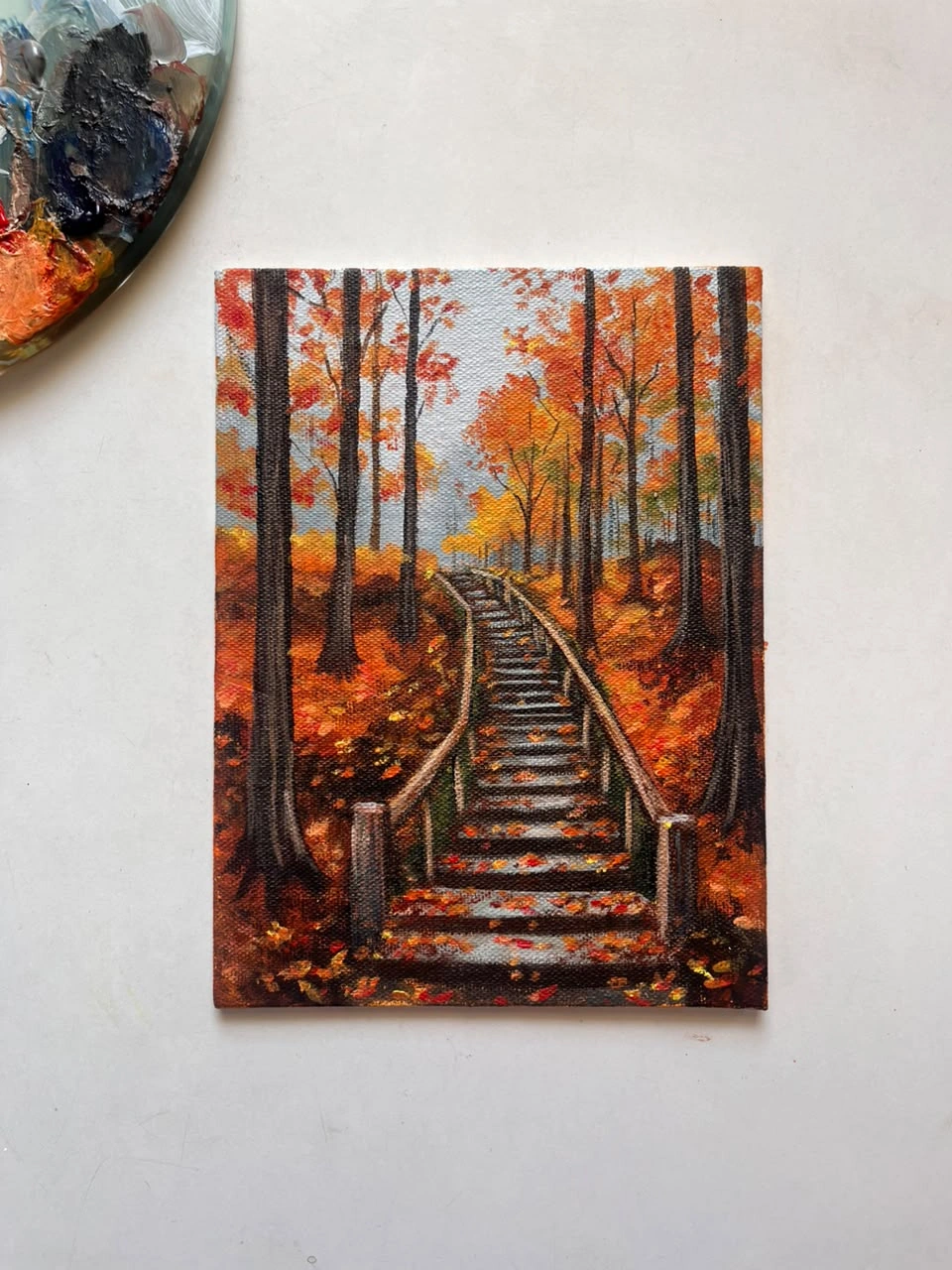 An autumn forest stairway painted in warm orange and gold